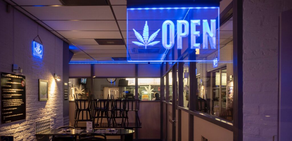 Inside of a Social Club, with neon "open" shield